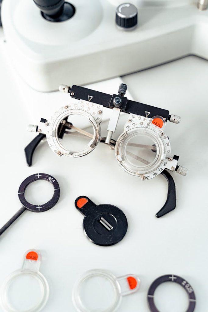 Close-up of optometry trial frame and lenses on white surface.
